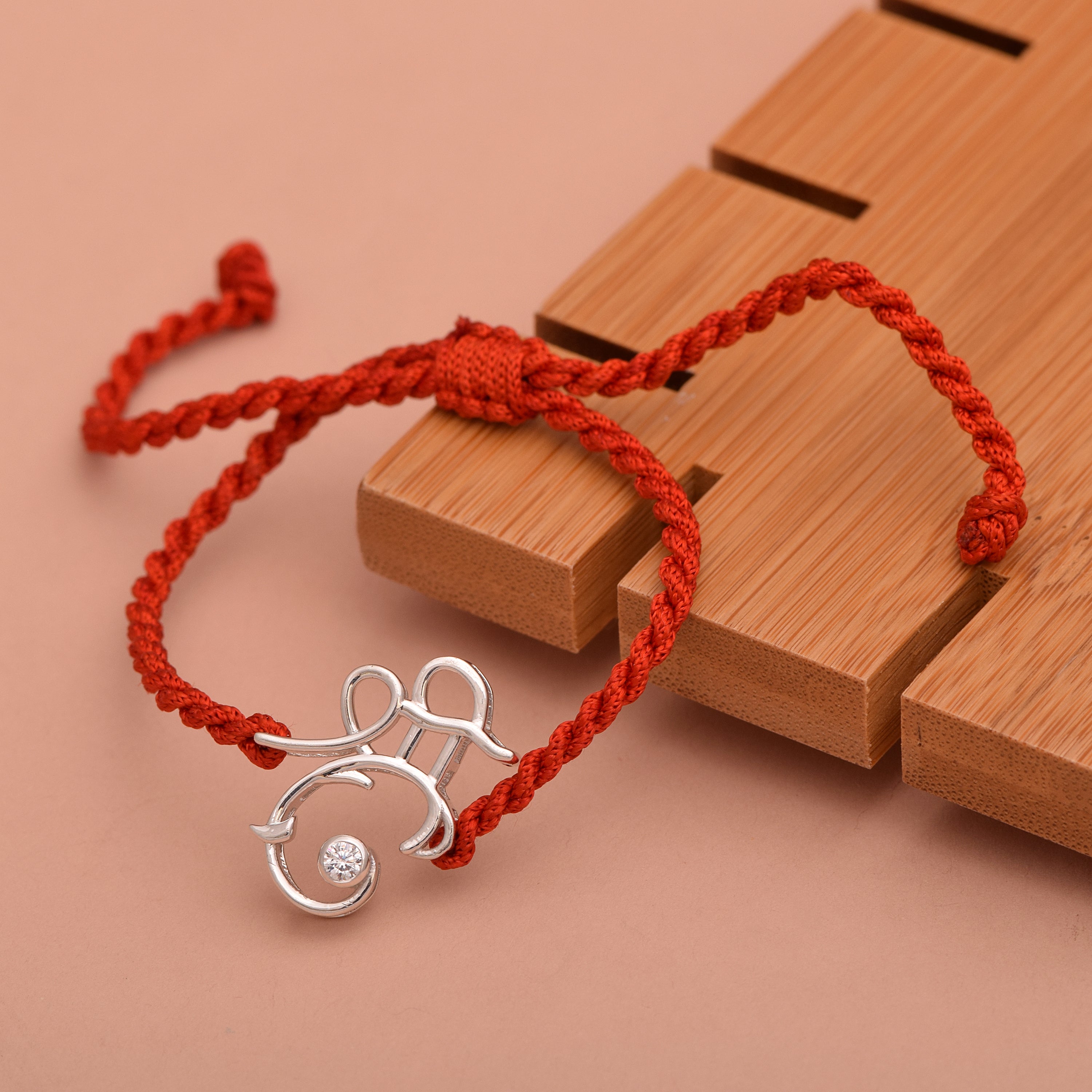 White CZ Ganesh Symbol Thread Rakhi Bracelet - Sterling Silver
